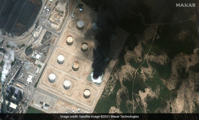 An oil storage tank burning in the Gaza conflict area following a rocket attack from Gaza in May.