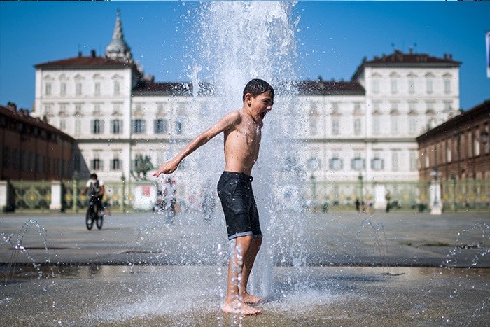 A boy cools off in the fountain in Piazza Castello in Turin, Italy. Temperatures are expected to rise sharply in Europe in the coming days.