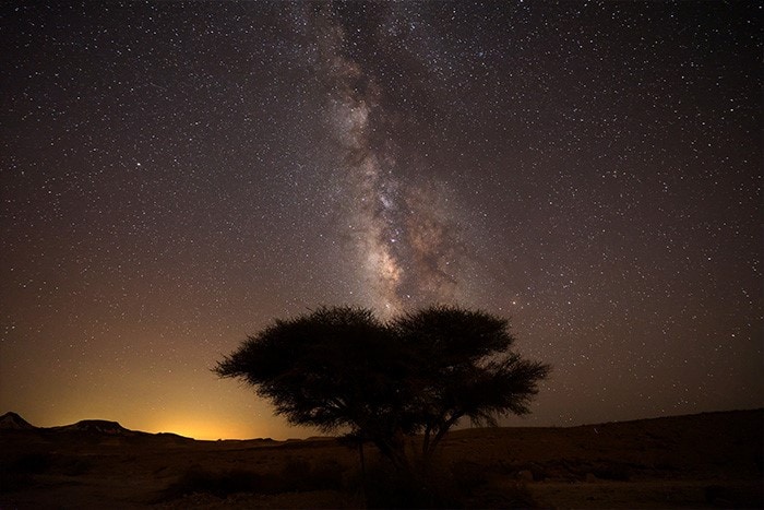 The Milky Way galaxy rises in the night sky above the Negev desert near the Israeli city of Mitzpe Ramon.