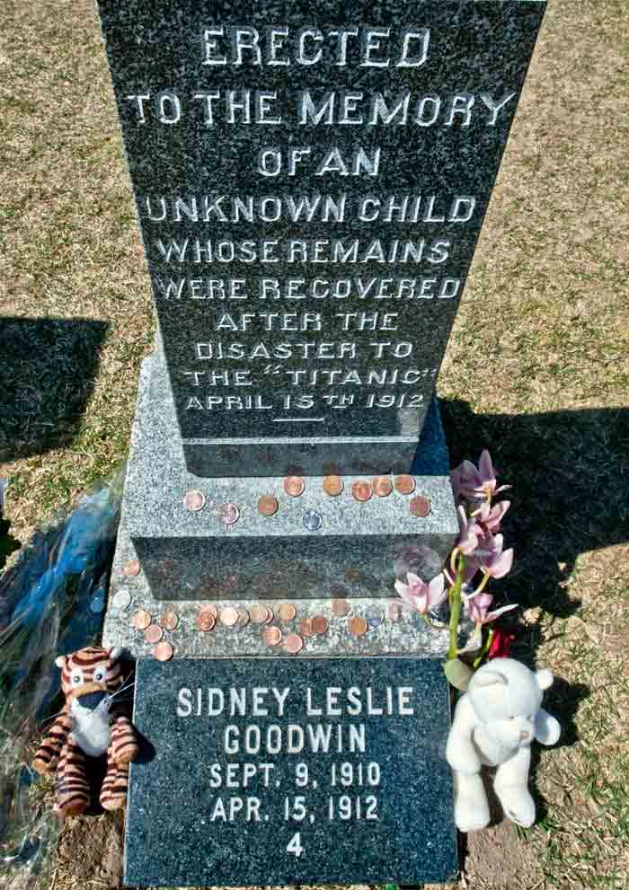 Coins, toys and flowers decorate the Fairview Cemetery tombstone of Sidney Leslie Goodwin, a 19-month-old English boy, who died during the sinking of the RMS Titanic. His unidentified body was recovered and until 2007, when the body was identified, was referred to as the unknown child. <br/> (AFP Photo)