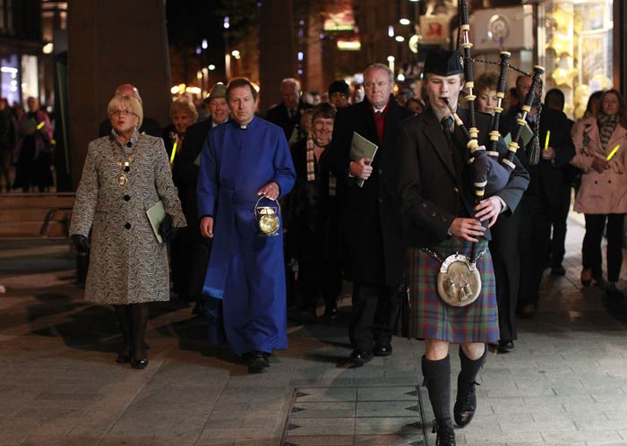 The Titanic was built in the Northern Irish capital Belfast, and was sailing from the English port of Southampton on its maiden voyage toward New York when tragedy struck. In this picture people walk behind a lone bagpiper to Belfast City Hall following a Titanic Commemoration service at St. Ann's Cathedral Belfast in Ireland. <br/> (AP Photo)