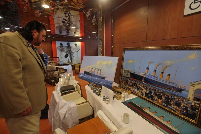 The centenary, was a global event with artists, scientists and museums engaged in months-long preparations for commemorations. In this picture a man looks at paintings depicting the Titanic made by artist and historian James A. Flood from Philadelphia, as the MS Balmoral Titanic memorial cruise ship approached the ship's final resting place. <br/> (AP Photo)