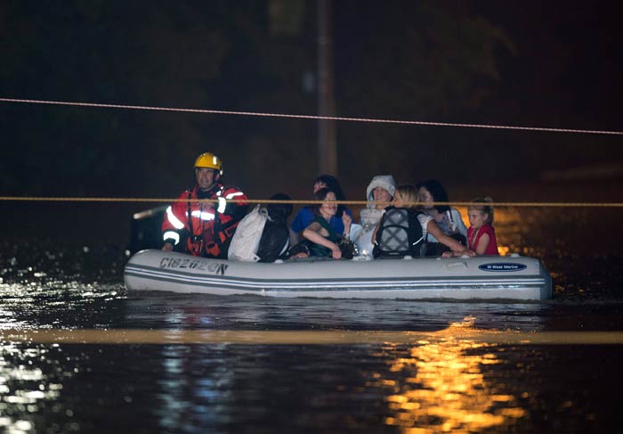 Toronto police and firefighters used small inflatable boats to rescue commuters from a double-decker train.