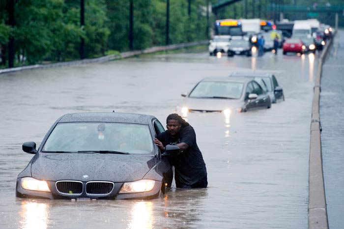 A severe thunderstorm caused flash flooding in Toronto, cutting power to at least 300,000 in Canada's largest city, shutting down subways, and leaving about 1,400 passengers stranded for hours on a commuter train filled with gushing water.