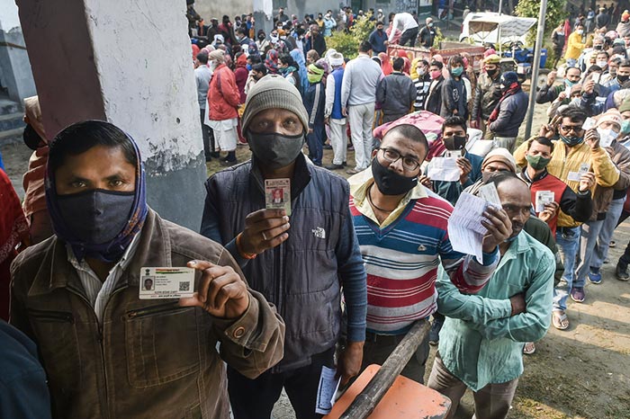 UP Election 2022: Voters queue up to cast their ballot at a polling station during the first phase of Uttar Pradesh state assembly elections.