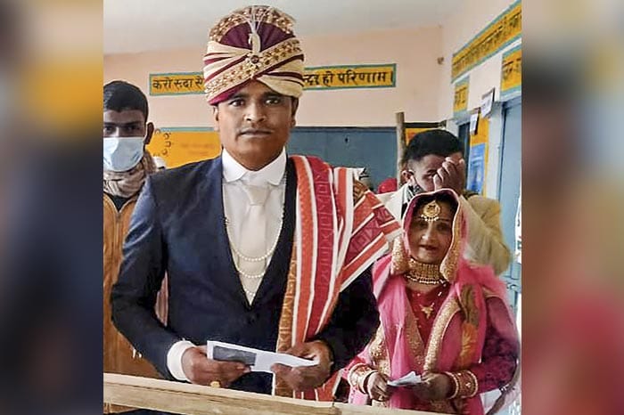 UP Election 2022: A newly-wed couple arrives at a polling station to cast votes, during the first phase of UP Assembly elections, in Meerut.