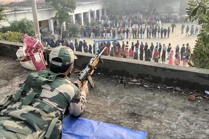 UP Election 2022: Security personnel guard polling station during the first phase of Uttar Pradesh state assembly elections