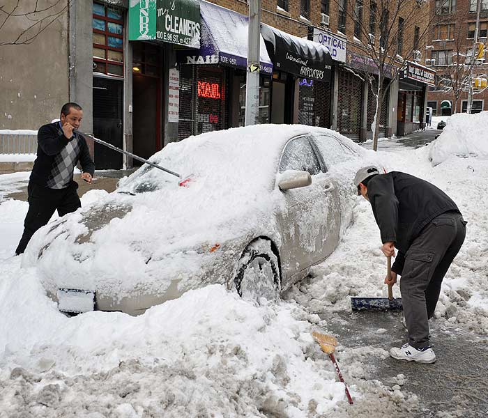 Coastal blizzard and flood warnings were in effect, but Massachusetts and Connecticut lifted vehicle travel bans as the storm slowly moved eastward on Saturday evening.