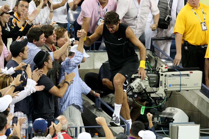 Juan Martin Del Potro of Argentina goes into the stands after defeating Roger Federer of Switzerland in the Men's Singles final on day fifteen of the 2009 U.S. Open.&nbsp; (AFP Photo)