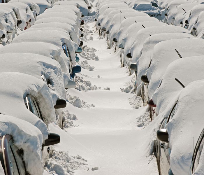 Rental cars wait to be dug out at an auxiliary lot at Dulles International Airport (IAD), days after the record snowstorm in Washington, DC.<br><br>Hundreds and hundreds of cars had to be dug out, one at a time, by hand. (AFP Photo)