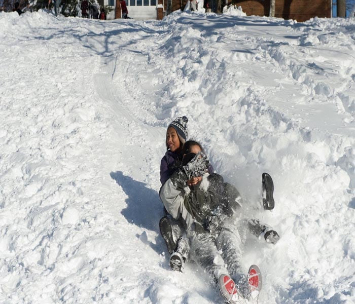 Children sled in the snow in Washington's Rock Creek Park after a record snowstorm hit the city.<br><br>Around 20-30 inches (50-75cm) fell on the US capital in the storm dubbed "Snowmageddon" which battered the US east coast.(AFP Photo)