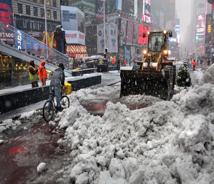 On Wednesday, the second blustery snowstorm to sweep across the Northeast in less than a week had made its way into the New York area, and officials had closed schools, courts and the U.N. headquarters. Seen here, Munic�ipal worke�rs clearing a sidew�alk in New York'�s Times Squar�e.(NYT Photo)