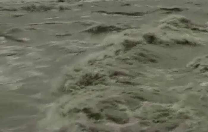 A close-up of the lethal currents in a river that has reached dangerous proportions thanks to heavy rainfall