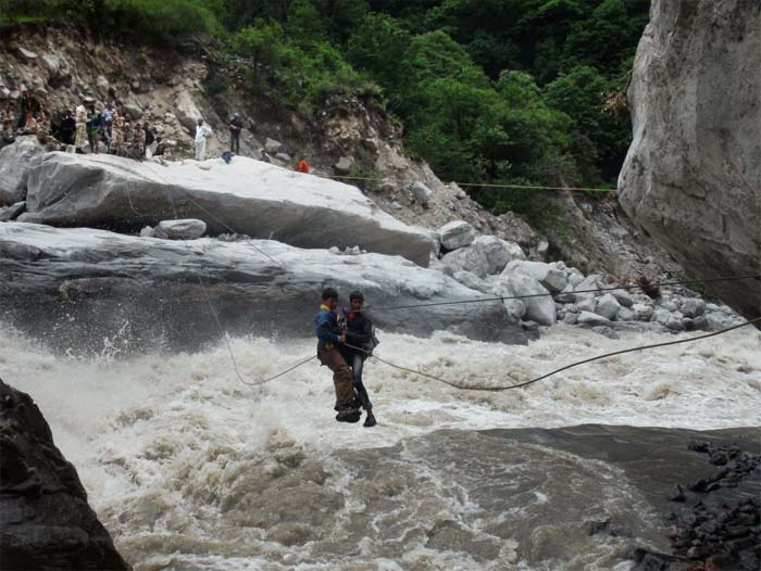 Seen here, an ITBP personnel rescuing flood victims with the help of a rope bridge over Alaknanda River in Lambagar.<br><br>For more information, go to <a href="http://www.ndtv.com/sos" class="fbld fn fl ">www.ndtv.com/sos</a>