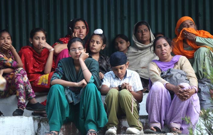 Pilgrims wait for the arrival of a rescue helicopter in Joshimath.<br><br>For more information, go to <a href="http://www.ndtv.com/sos" class="fbld fn fl ">www.ndtv.com/sos</a>