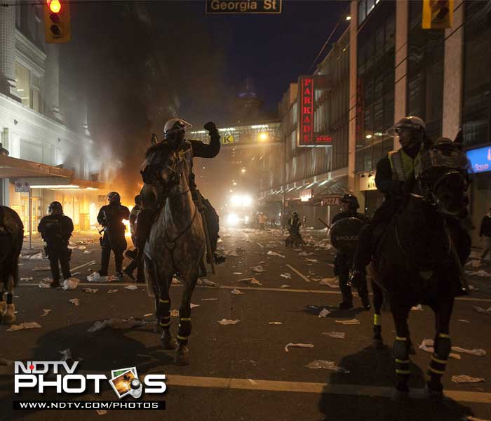 Police on horseback had to come into action after a riot following the Vancouver Canucks being defeated by the Boston Bruins in the NHL Stanley Cup. (AP Photo)