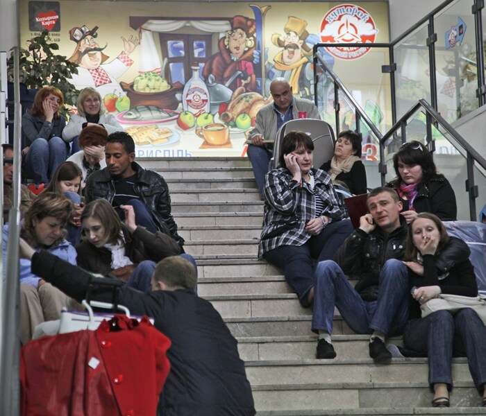 Passengers wait for their flights at Borispol airport, near Kiev, as hundreds of commercial flights across northern and eastern Europe are canceled because of a drifting plume of volcanic ash originating from a volcanic eruption in Iceland. (AP Photo)