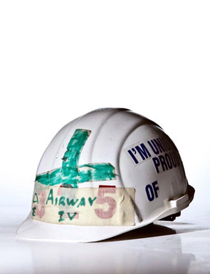 "I was an emergency medicine resident at the N.Y.U./Bellevue hospitals on Sept. 11. On the days following the disaster, we were charged with setting up a medical station at the site of the collapsed twin towers. I recall the surreal van ride down there, driving underneath huge pieces of the towers set askew between buildings and into the fluffy debris close to the site. As we got out of the van, a construction worker (steelworker, I believe) walked by and said, 'You'll need this.' He handed me this hard hat. Responsible for airways and IV's on the medical team, I fashioned a green cross (I had no red ink), and wrote the words "Airway/IV" on it. I never saw him again to say thanks." -Lars K. Beattie. <a href=" http://www.ndtv.com/article/world/9-11-memories-what-we-kept-132551" class="fg fn fl fs12">Read: 9/11 memories - What we kept</a><br><br>(Photo courtesy: Tony Cenicola, The New York Times)