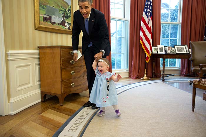 Barack Obama with the daughter of a departing staff member in the Oval Office </br>Photo Credit:</b> <a href=" http://www.whitehouse.gov/photos-and-video/2014-photos" rel="nofollow" target="_blank"><b>Pete Souza, Director and Chief Official White House Photographer</b></a>