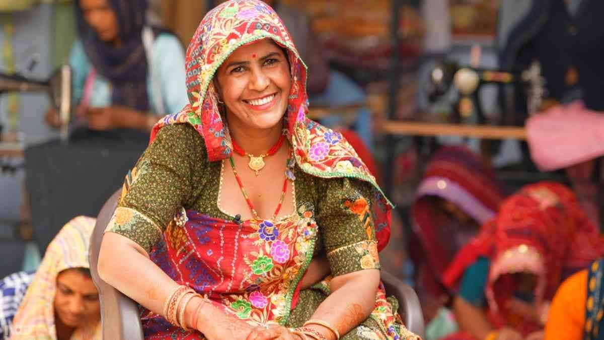 In Rajasthan's Neemki village, Sikar district, 35-year-old Vimla Devi collaborates with her husband Mewaram at their shared tailoring setup, adjusting a salwar kameez pattern on her Usha machine acquired after 2021's Reengus training. Widowed young with children Ankit and Monika, her shift from farm labor to monthly ?8,000-?10,000 income now covers private schooling, as she teaches locals and warns against child marriages that stole her own childhood.