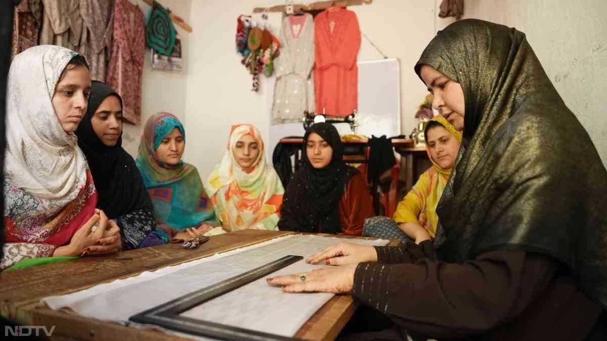 Marifat shares a heartfelt moment with her 4.5-year-old daughter, who still believes her father sends money from afar, as they sit amid bolts of vibrant fabric in their home-turned-workspace. From double MA dreams deferred to embracing stitching over unstable jobs, Marifat's leap of faith in the Usha program rebuilt her confidence, allowing her to employ four women and vow to help 10-20 more rise from despair.