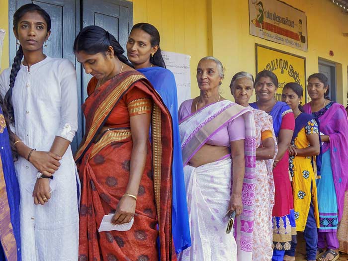 Women wait in a long queue to cast their votes at a polling station, during the third phase of Lok Sabha polls, at Batheri in Kerala's Wayanad.