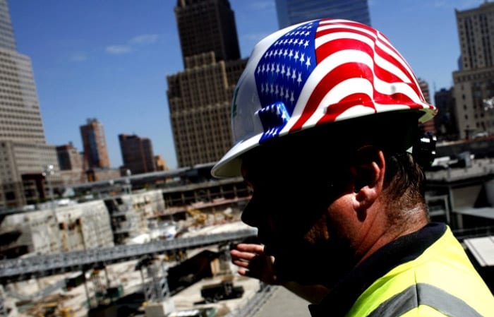 An American Flag adorns the helmet of a worker from E.E. Cruz, the New Jersey construction firm responsible for building the World Trade Center Memorial and Museum, as he stands at ground zero, on Aug. 17, 2006 in New York. (AP Photo)