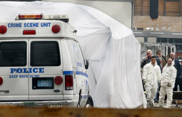 Members of the New York Police Department Crime Scene Unit are seen at the World Trade Center site in New York, on Oct. 20, 2006. The search for the remains of victims moved across the street from the site of the World Trade Center to the lot of a destroyed church, where important relics, including the bones of three saints, may also be buried. (AP Photo)