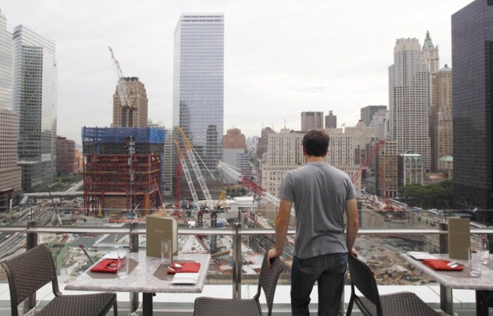 A visitor to the newly-opened World Center Hotel overlooks the World Trade Center construction site, on June 9, 2010, in New York. The rising tower of One World Trade Center is at left. The visitor is standing in the View of the World Terrace Club, the hotel's private roof-top restaurant. The boutique hotel has 169 rooms, most with views of the World Trade Center or Lower Manhattan. (AP Photo)