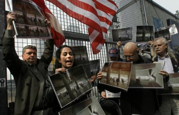 Rosaleen Tallon, second from left, leads a group of 9/11 family members in protest against the construction of a 9/11 memorial at Ground Zero at the World Trade Center site in New York, on March 13, 2006.  Protesters held pictures of the proposed memorial saying it was not a fitting memory to 9/11 victims because of its underground design. Tallon's, brother Sean Tallon, 26, a firefighter from Ladder 10, died in the 9/11 attacks.  (AP Photo)