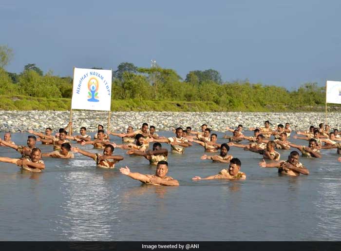 Personnel of 9th Battalion of Indo-Tibetan Border Police (ITBP) perform 'River Yoga' in Digaru river on  International Day of Yoga near Teju, Lohitpur.