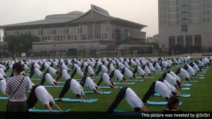 Hundreds of people assembled in Beijing early on Sunday morning for a yoga session to mark the first International Day of Yoga.