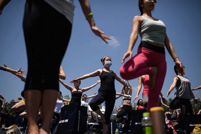 A woman wearing a mask takes part in the International Yoga Day event in Seoul on June 21, 2014. Meanwhile South Korea reported three new cases of MERS as health authorities remained vigilant about the spread of the virus.