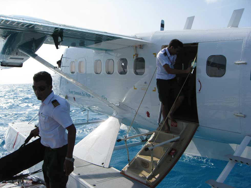 The luggage was taken out by hand on this raft-airport.
<br><br>
And while we were ferried to the island, the Maldivian Air taxi got ready to fly back to another raft international airport.