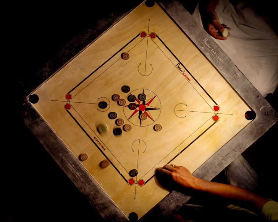 Irfan, has been in love of the game for 30 years. He and many others play here for 4 to 6 hours every day and go into a craze with many more hours over the weekends. He got his job at LIC, a recent promotion and a half day flexi-work schedule, all because of Carrom. LIC like some of the other PSUs promotes the game through quota schemes. This is a motivation for many who come here. They could rather be doing something else but they choose to do this, every day like a religion.<br>
Photo Courtesy: Ritvik Gaud