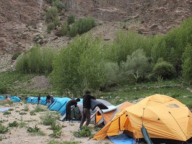 Lighting The Himalayas: Parked Tents, Stars in the Night Sky