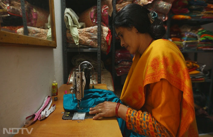 Tulsi Shah exemplifies the chain impact of the USHA Silai School Training Program that spreads in the country through the Silai School Women Entrepreneurs. She has trained over 70 women in stitching, sewing, hemming, and other tricks of the trade. Having employed several women, she now hopes to expand her enterprise and liberate herself as well as her community.