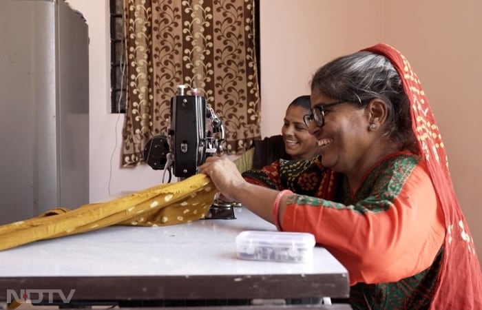 Sakuben Ahir and her students craft traditional bridal outfits at Usha Silai School, where women build confidence, skills, and the ability to create financial independence. This empowers them to make informed decisions about their lives and break free from cycles of poverty and dependence.