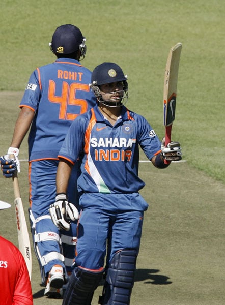 Indian batsman Virat Kohli raises the bat after his half-century in the fifth ODI of the Micromax Cup Triangular Series in Harare. (AFP Photo) 5th ODI: India vs Sri Lanka