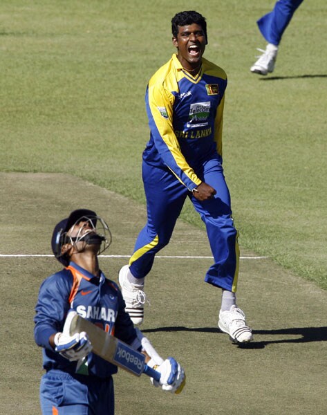 Sri Lankan bowler Thissara Perera celebrates after he took the wicket of Indian batsman Dinesh Karthik in the fifth ODI of the Micromax Cup Triangular Series in Harare. (AFP Photo) 5th ODI: India vs Sri Lanka