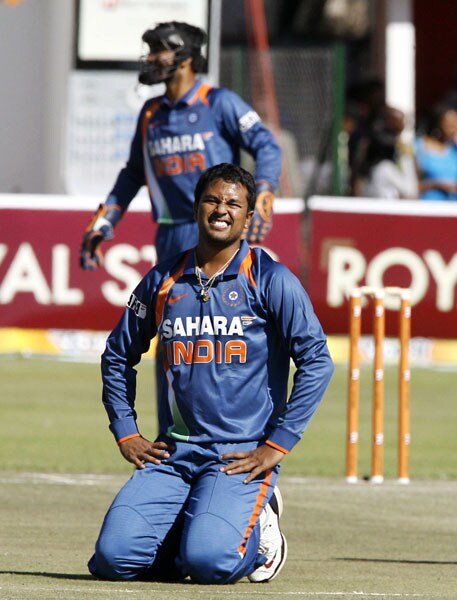 Indian bowler Pragyan Ojha is on the ground after missing the ball against Sri Lanka in the fifth ODI of the Micromax Cup Triangular Series in Harare. (AFP Photo) 5th ODI: India vs Sri Lanka