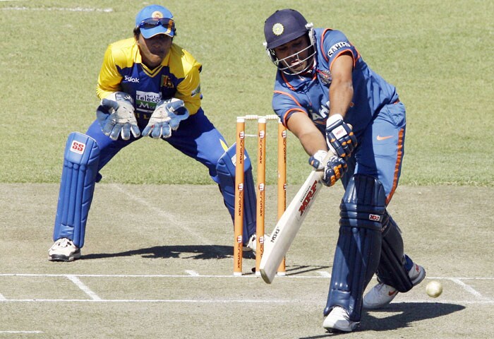 Indian batsman Rohit Sharma takes a shot as Sri Lanka wicketkeeper Dinesh Chandimal watches him in the fifth ODI of the Micromax Cup Triangular Series in Harare. (AFP Photo) 5th ODI: India vs Sri Lanka