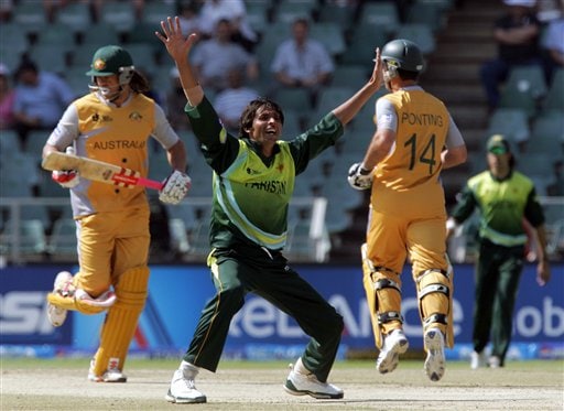 Pakistan's bowler Mohammad Asif, center, appeals unsuccessfully for a LBW against Australia's batsman Andrew Symonds, left, as teammate Ricky Ponting, right, makes a run during their Super Eight's of their Twenty20 World Championship cricket match against Australia at the Wanderers Stadium in Johannesburg, South Africa, Tuesday, Sept. 18, 2007. Australia vs Pakistan