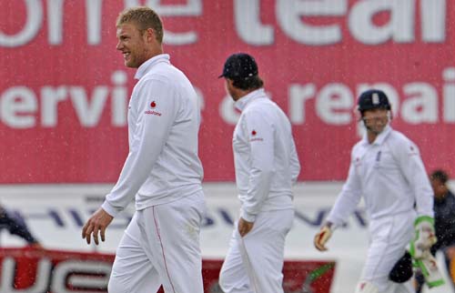 Andrew Flintoff and teammates leave the field as rain stops play on the third day of the first Ashes Test between England and Australia in Cardiff. (AFP Photo) Ashes: 1st Test, Day 3