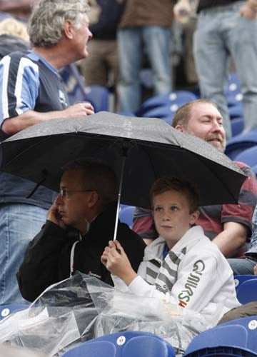 Cricket fans are seen during a rain break on the third day of the first Ashes Test between England and Australia in Cardiff. (AP Photo) Ashes: 1st Test, Day 3