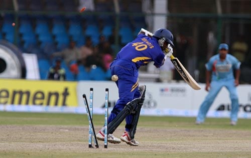 Ajanta Mendis is bowled by Rudra Pratap Singh in the Asia Cup final. Final - India vs Sri Lanka