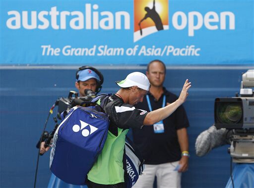 Australia's Lleyton Hewitt leaves the court after losing to Chile's Fernando Gonzalez during a men's singles match at the Australian Open on Tuesday. (AP Photo) Australian Open Day 2