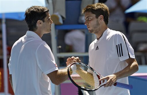 France's Gilles Simon greet Spain's Pablo Andujar at the net after beating him in their men's singles match at the Australian Open on Tuesday. (AP Photo) Australian Open Day 2