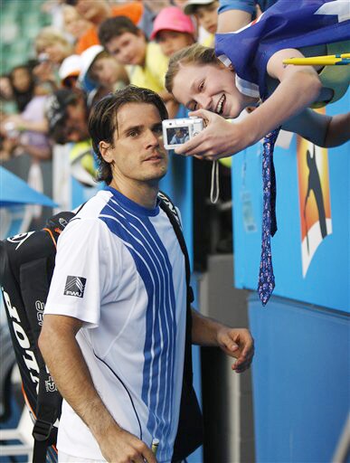 Germany's Tommy Haas poses for a photo for a spectator after beating Argentina's Eduardo Schwank in a men's singles match at the Australian Open on Tuesday. (AP Photo) Australian Open Day 2