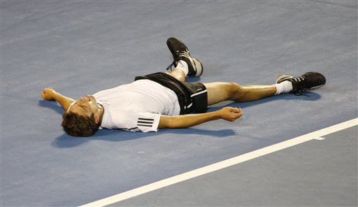 France's Gilles Simon lays on the court after he fell during his men's singles quarterfinal match against Spain's Rafael Nadal at the Australian Open in Melbourne on Wednesday. (AP Photo) Australian Open Day 10